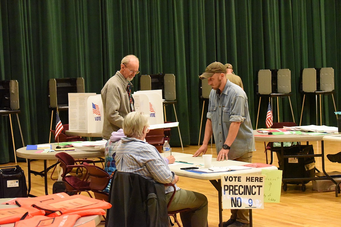 Lincoln County election judges assist a voter Tuesday, June 4, 2024, at the Memorial Center during the primary election. (Scott Shindledecker/The Western News)