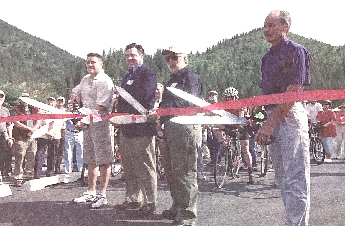 Sixty cyclists prepared to test ride the Trail of the Coeur d’Alenes after the ribbon cutting by (from left): Francis SiJohn of the Coeur d’Alene Tribe, Scott Moore of Union Pacific Railroad, Ernie Lombard of the state Department of Parks and Recreation and Mullan Councilman Dan White.