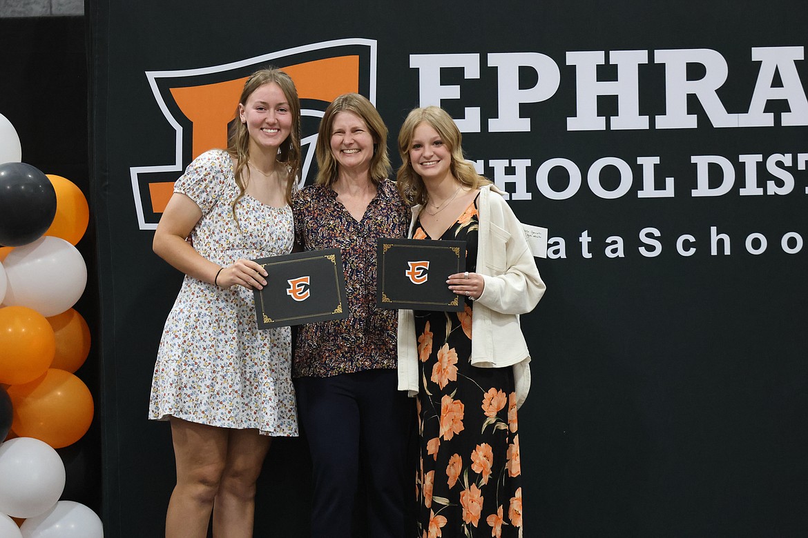 Addison Mills, left, and Karissa Cleveringa, right, stop for a photo opp with Ephrata High School Librarian Sheila Massey. Both students earned scholarships this year after working hard during their high school careers.