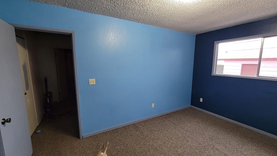 The after: A bit of color later and the room had moved into a serene blue with a navy accent wall and gray trim.