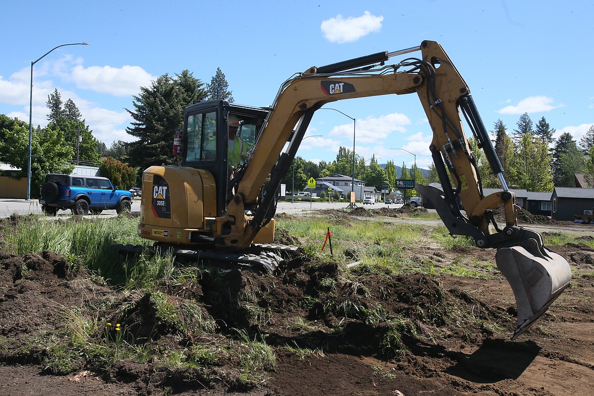 Interstate Concrete and Asphalt equipment operator Roger Nowakowski runs a mini-excavator Wednesday morning on the site of the future East Sherman Food Trucks food court that is expected to be open in September.