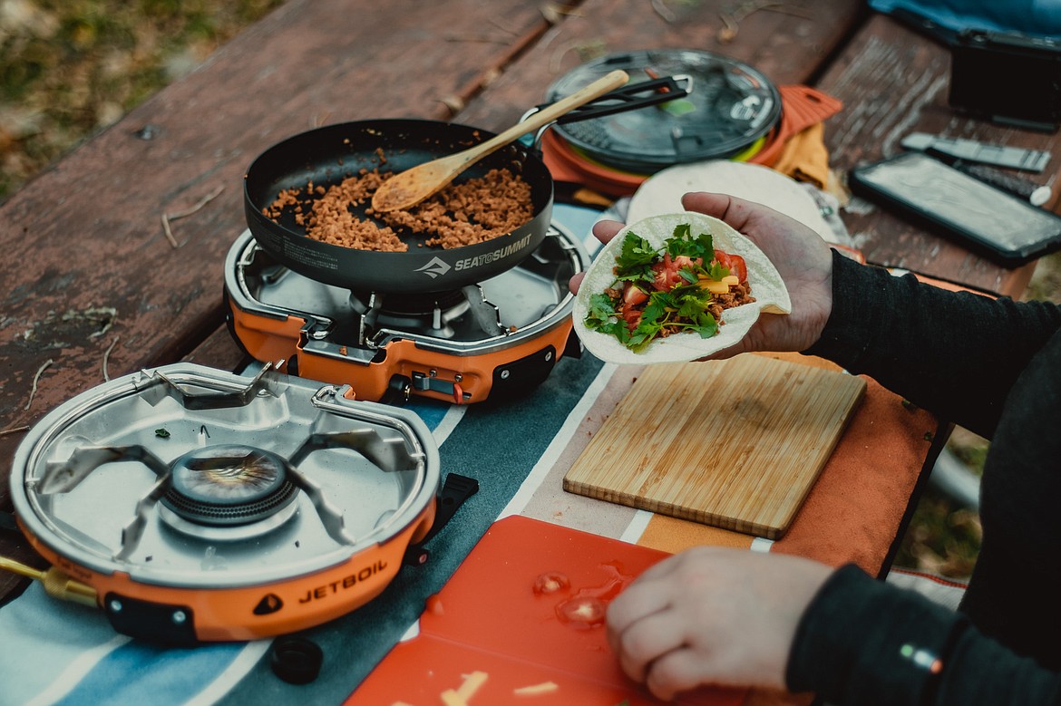 Amanda Zito prepares a meal while motorcycle camping. (Photo courtesy of Amanda Zito)