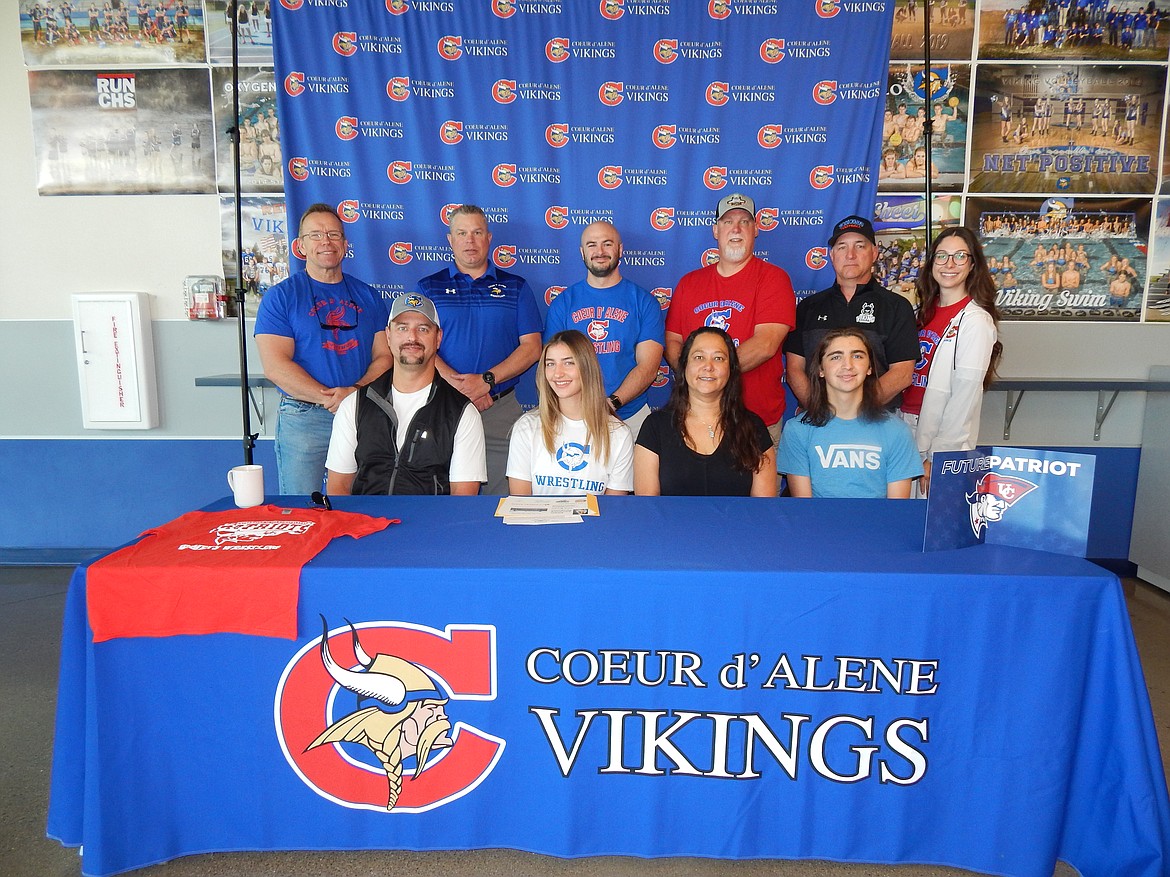 Courtesy photo
Coeur d'Alene High senior Cara Brown recently signed a letter of intent to wrestle at NAIA University of the Cumberlands in Williamsburg, Ky. Seated from left are J. Brooks Brown (dad), Cara Brown, Jennifer Brown (mom) and Cayden Brown (twin brother); and standing from left, Mike Randles, Coeur d'Alene High principal; Kelly Moffat, Coeur d'Alene High assistant wrestling coach; Jake Graham, Coeur d'Alene High assistant wrestling coach; Jeff Moffat, Coeur d'Alene High head wrestling coach; Shawn Amos, Coeur d'Alene High head football coach; and Victoria Beecher, Coeur d'Alene High athletic director.