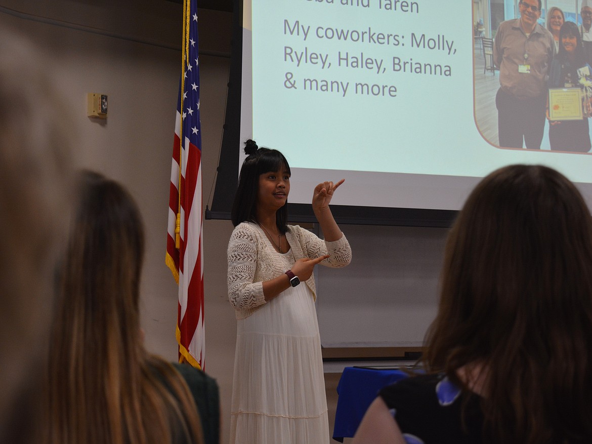 Chayana Frahm signs her Project SEARCH internship presentation during the graduation ceremony Thursday at Kootenai Health.