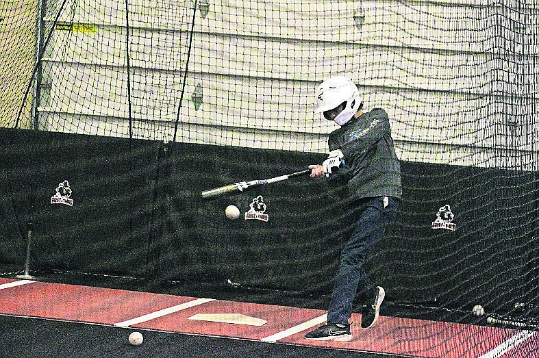 JASON ELLIOTT/Press Lars Bazler takes a swing in a batting cage at the First and Third Indoor Baseball/Softball Facility in Hayden.