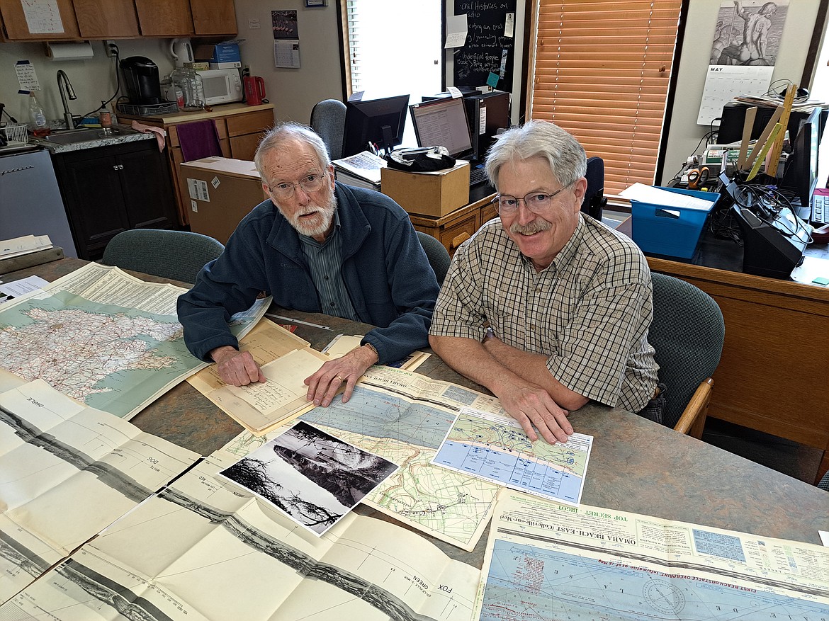 Bonner County History Museum volunteers Will Valentine and Ken Conger are pictured studying Omaha Beach maps and documents used during the D-Day invasion as they prepared for a recent exhibit honoring the life of Sagle native Private Frank Bradetich who killed on Omaha Beach June 6, 1944.