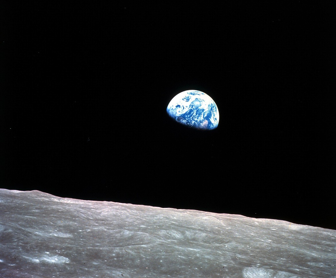 This Dec. 24, 1968, file photo made available by NASA shows the Earth behind the surface of the moon during the Apollo 8 mission. Retired Maj. Gen. William Anders, the former Apollo 8 astronaut who took the iconic “Earthrise” photo showing the planet as a shadowed blue marble from space in 1968, was killed Friday, June 7, 2024, when the plane he was piloting alone plummeted into the waters off the San Juan Islands in Washington state. He was 90. (William Anders/NASA via AP, File)