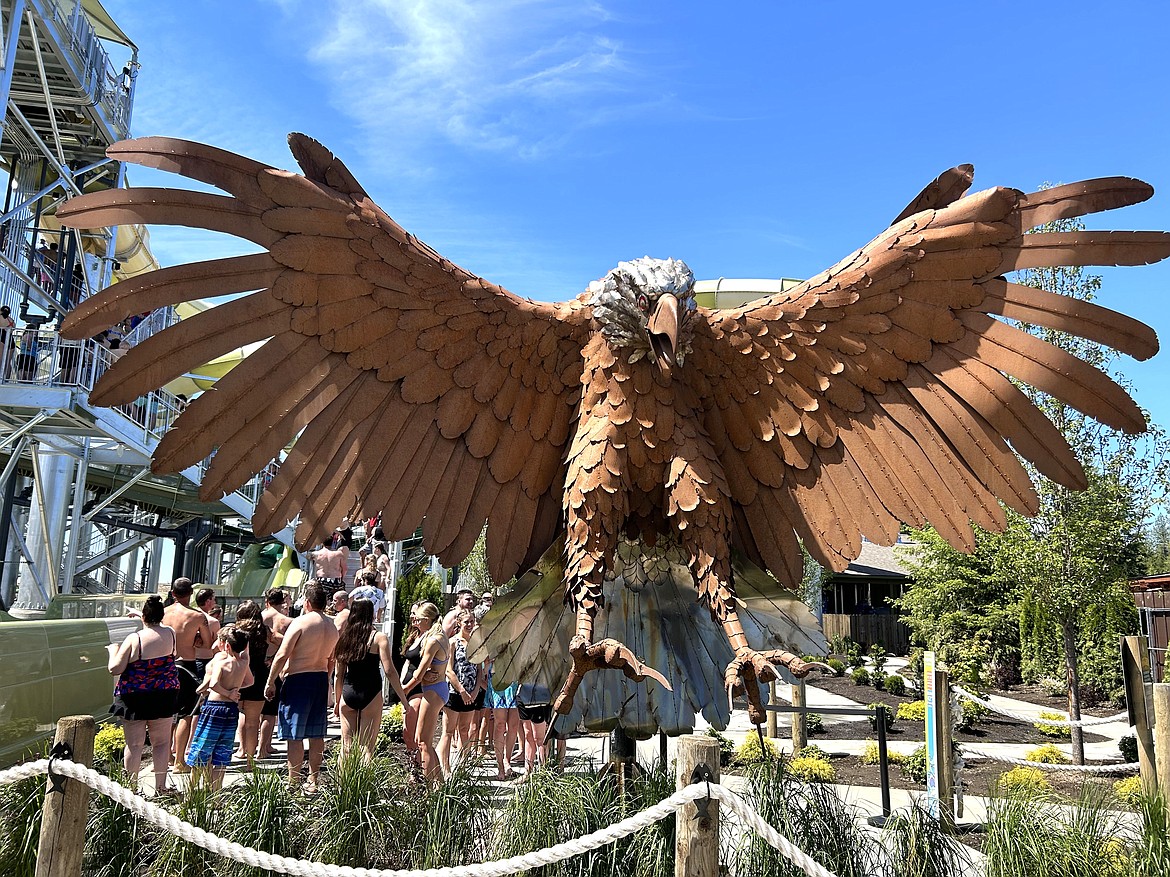 An eagle looks over the crowd as people wait in line to ride Eagle Hunt at the grand opening of the Emerald Forest at Silverwood Theme Park on Saturday.