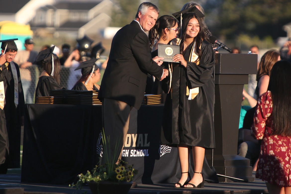 A Royal High School graduate receives her diploma during Friday’s graduation ceremony at David Nielsen Memorial Field.