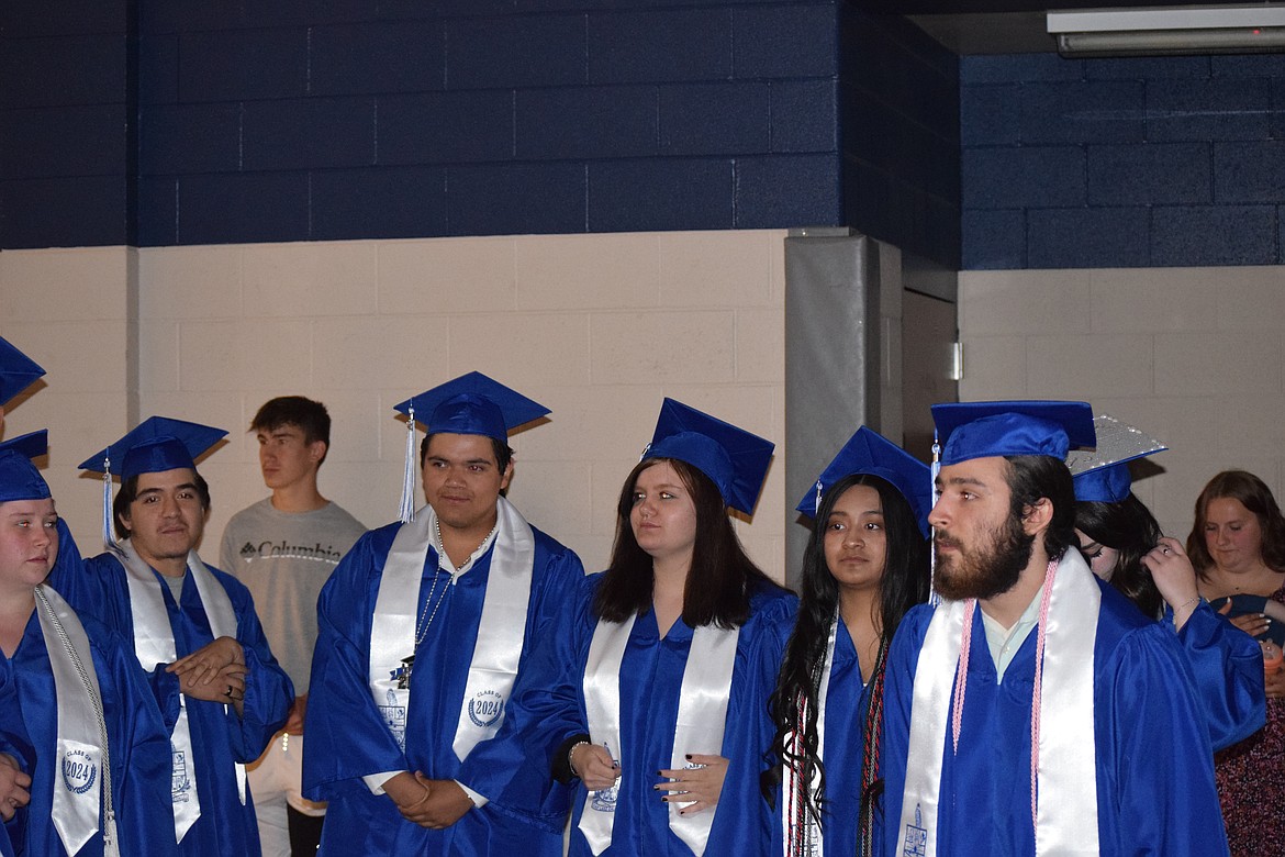 Soap Lake grads line up to the side of the gym prior to walking across the stage to be presented with their diplomas.