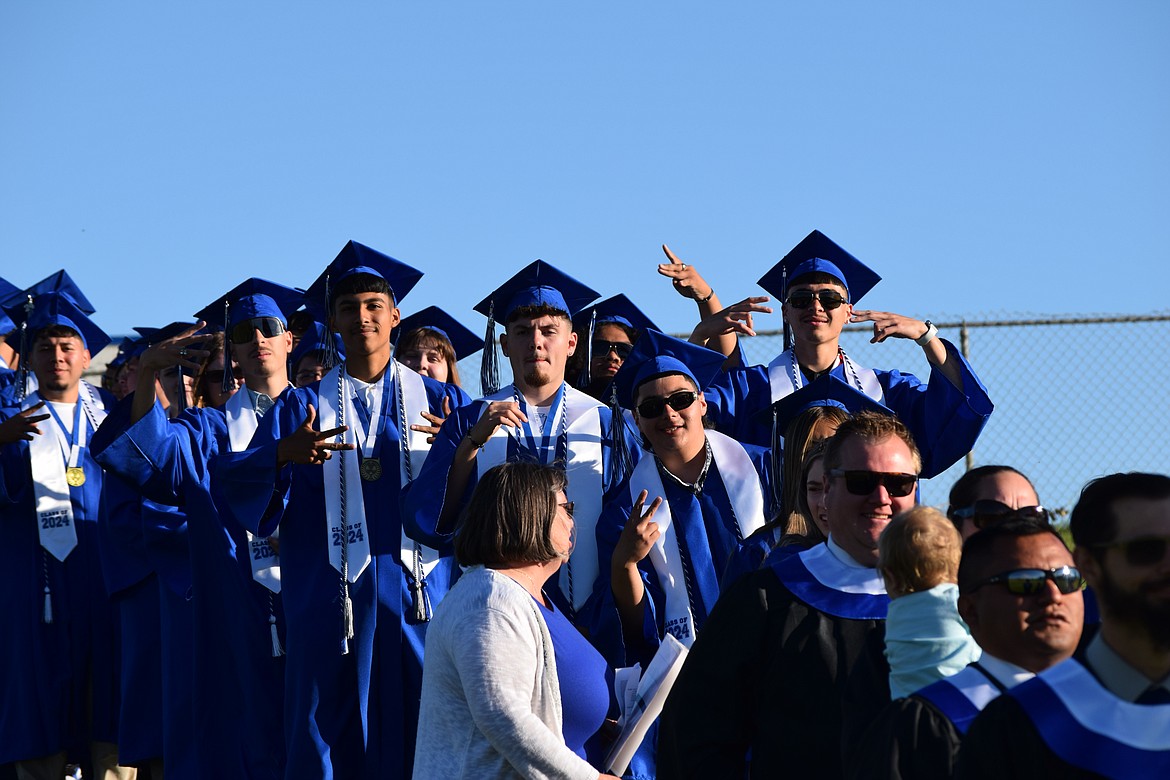 Warden's graduating class of 2024 lined up to walk onto the field at the school's celebration in their honor, led by teachers at the high school.