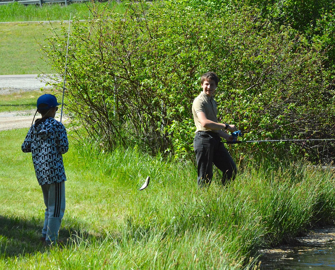 These boys found success on Saturday over by the drain leading out of Savenac Pond in Haugan where a group of fish were gathered. (Mineral Independent/Amy Quinlivan)