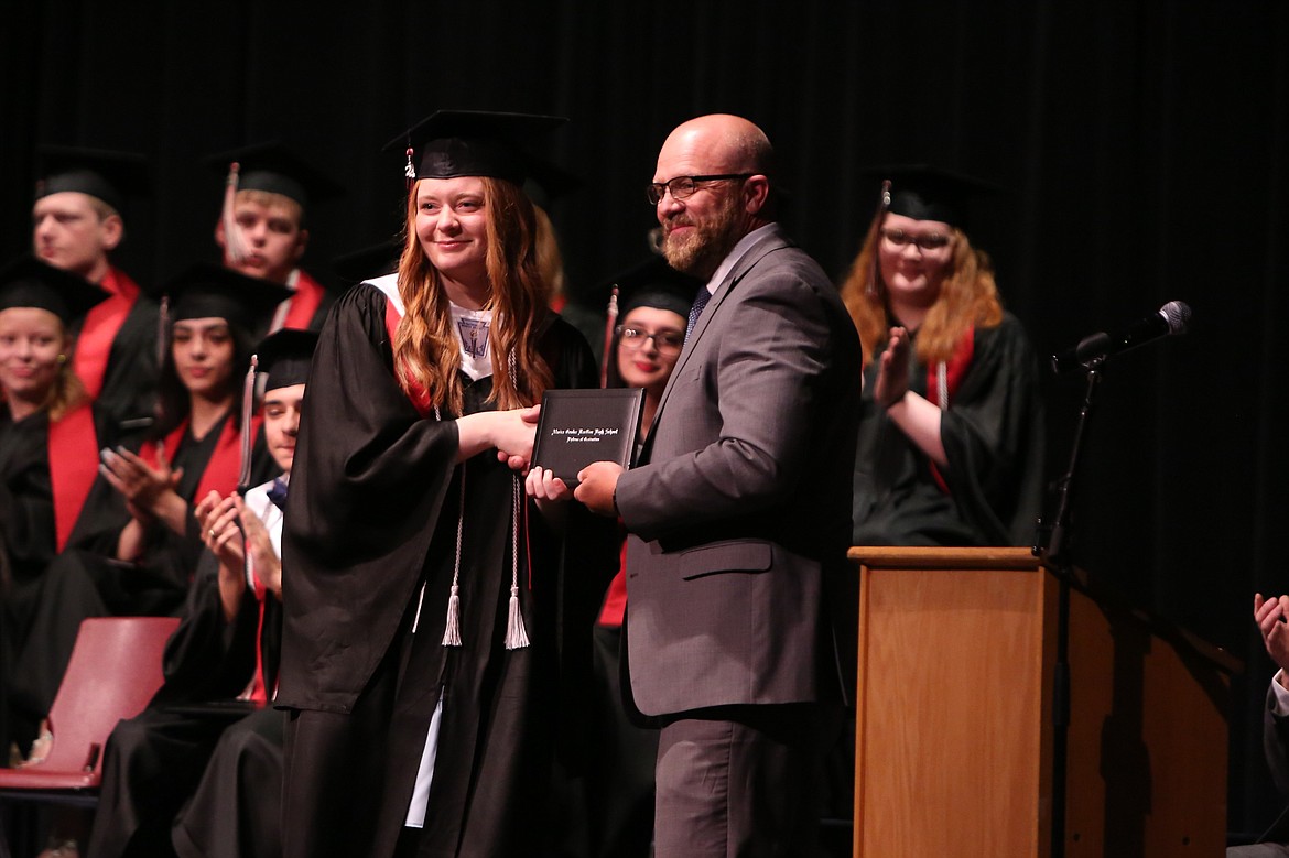 An Almira/Coulee-Hartline graduate receives her diploma at Saturday’s graduation ceremony in Coulee City.