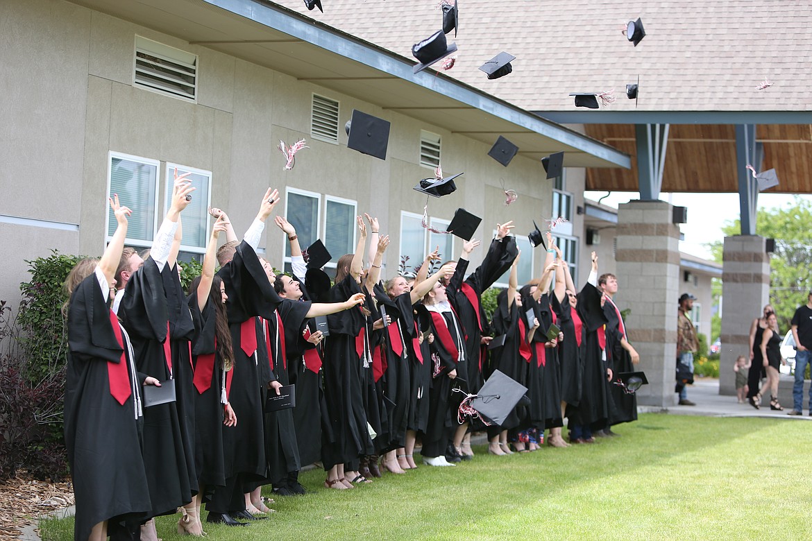 The Almira/Coulee-Hartline graduating class tosses their caps into the air following Saturday’s ceremony.