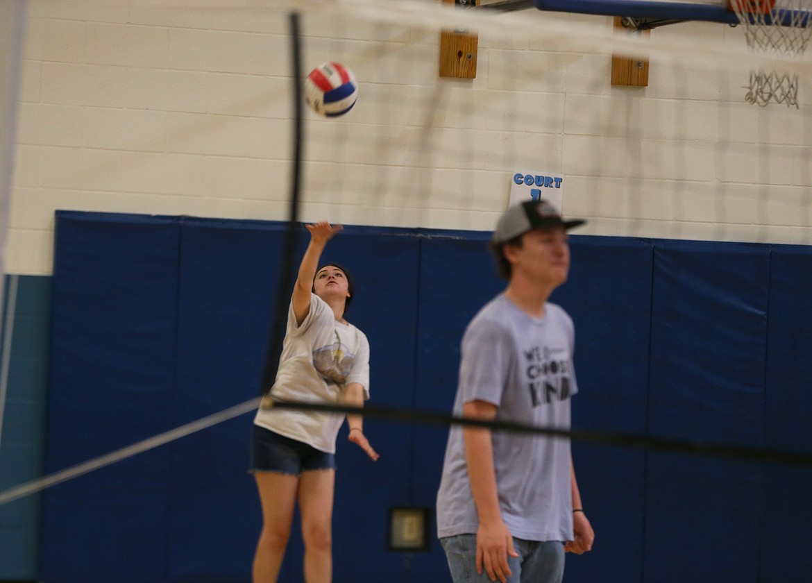 Kaitlin Andrews, 14, pops a volleyball into the air Thursday during gym time at the Post Falls Boys and Girls Club. Also pictured: Youth development specialist Cale Carver.