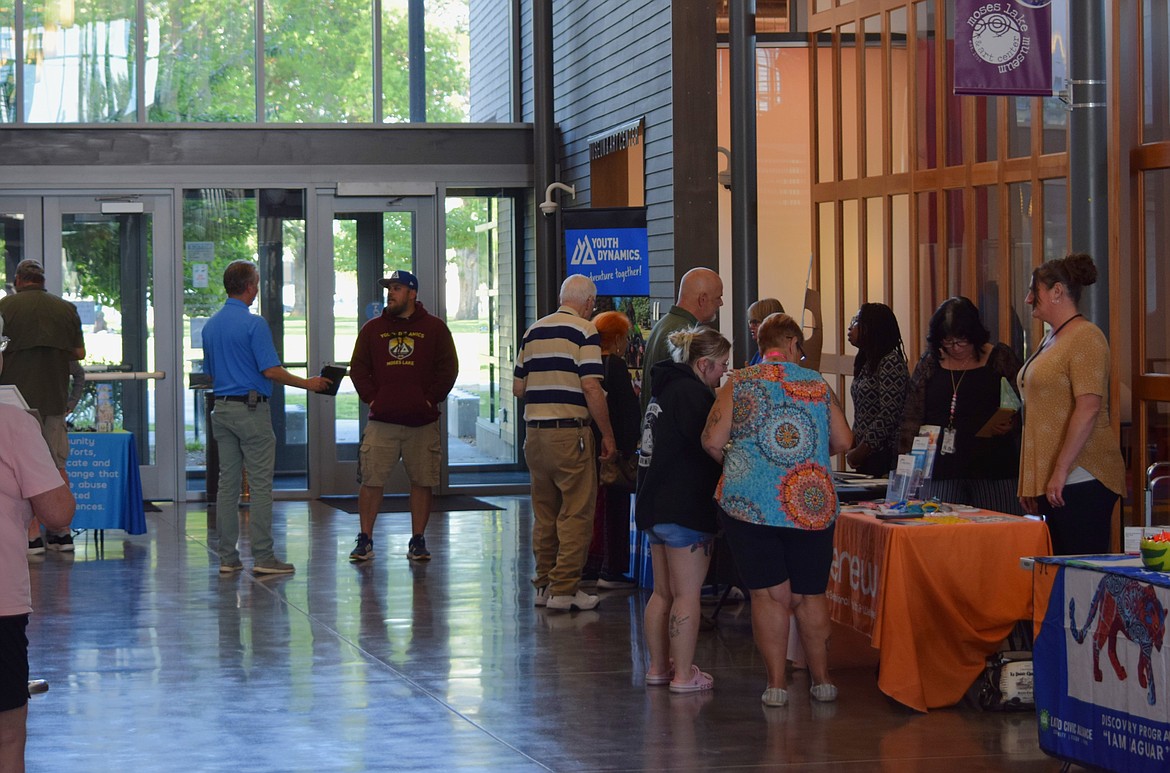 Moses Lake community members visit informational booths at the Moses Lake Civic Center Thursday before the Moses Lake Community Coalition’s town hall meeting