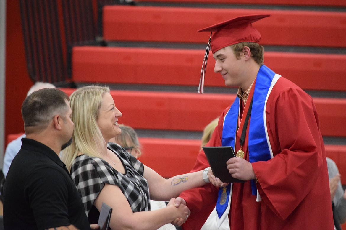 A Lind-Ritzville High School graduating senior accepts his diploma during the Class of 2024’s commencement ceremony Saturday, which saw 34 seniors graduate in total.