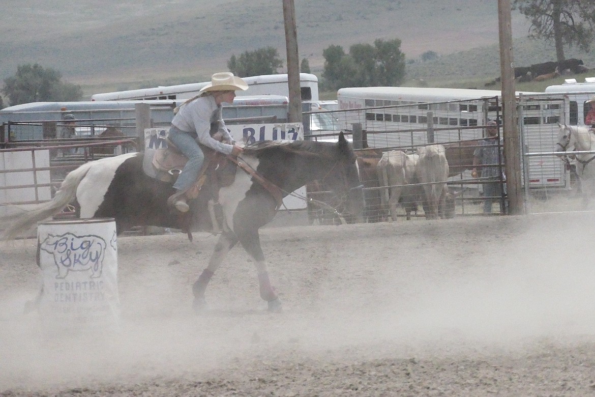 A junior ladies barrel racer plows through arena dust during her run at the Homesteader Days Rodeo this past Sunday in Hot Springs.  (Chuck Bandel/VP-MI)