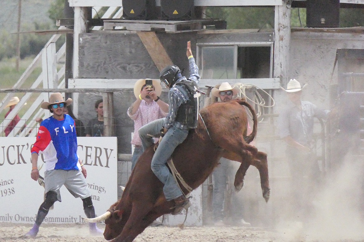 A contestant in the steer riding competition at this past weekend's Homesteader Days Rodeo in Hot Springs tries to stay aboard while eating a moutful of dust during this past Sunday's rodeo finals. (Chuck Bandel/VP-MI)