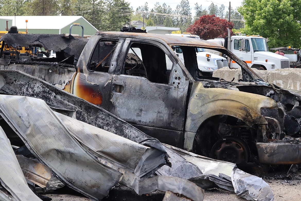 The charred remains of a Coeur d'Alene police vehicle sit outside a building  that was destroyed in a fire on Sunday.