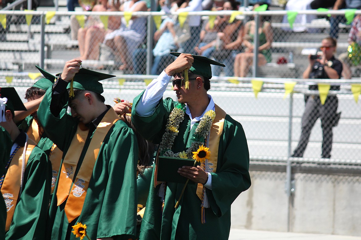 The ceremony over, Quincy graduates turn the tassel.