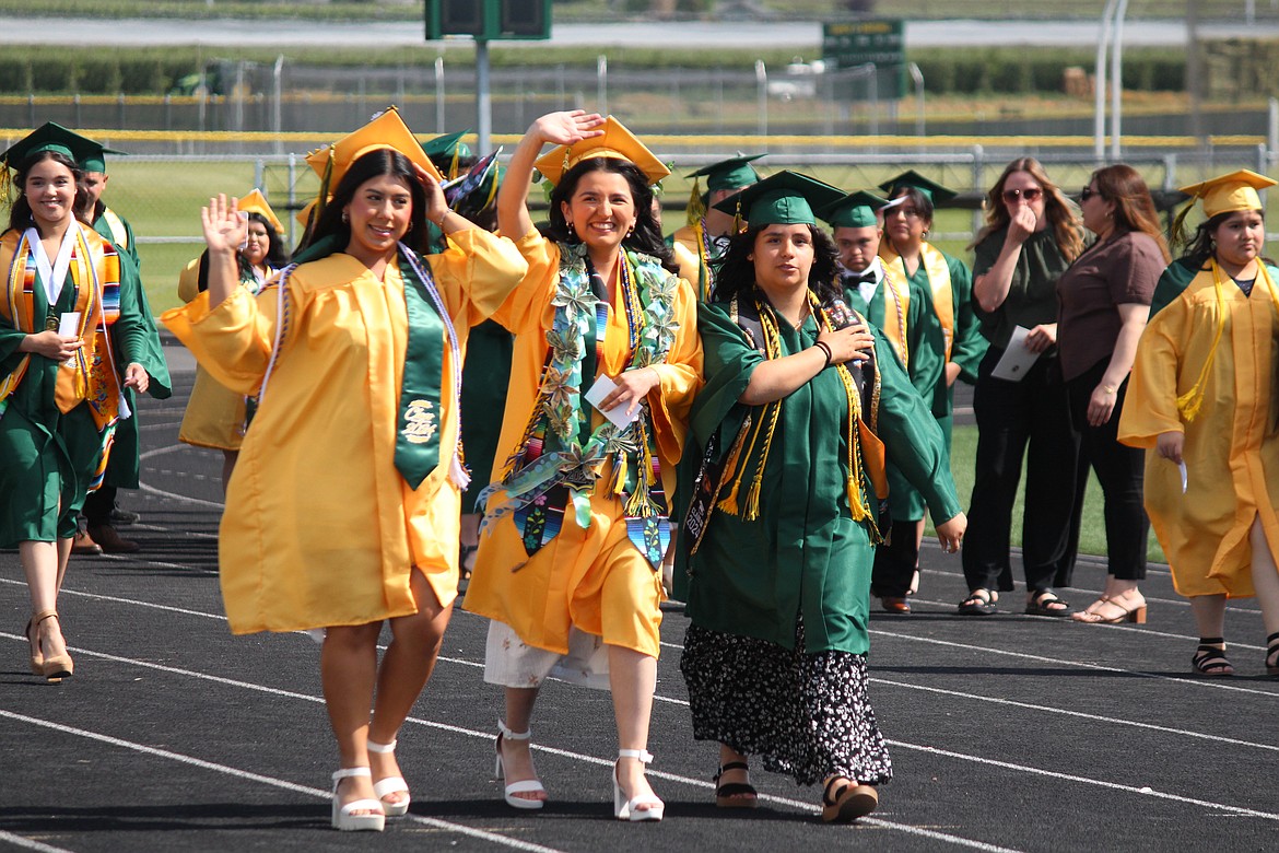 Seniors enter the stadium during graduation at Quincy High School.