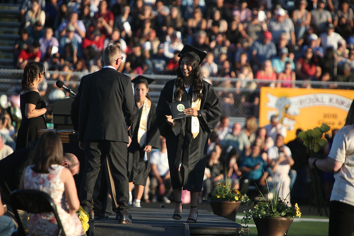 A Royal High School graduate smiles while crossing the stage after receiving her diploma during Friday’s graduation ceremony.