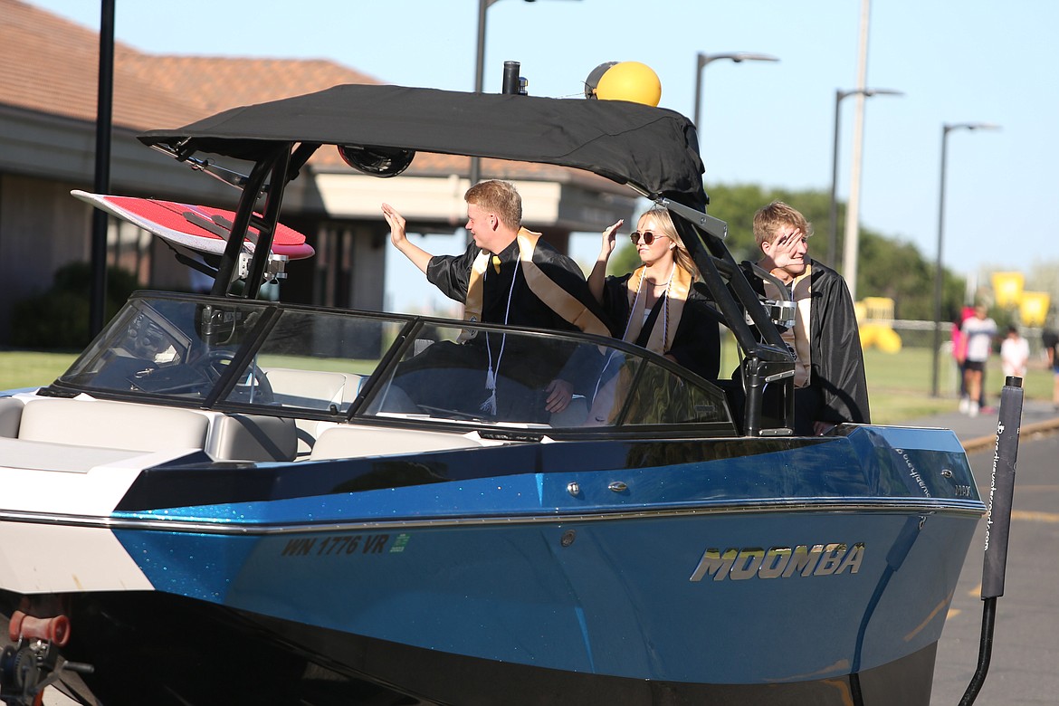 Graduates decked out their vehicles in various decor for Friday’s graduation parade, including this trio who cruised the streets of Royal City in a towed boat.