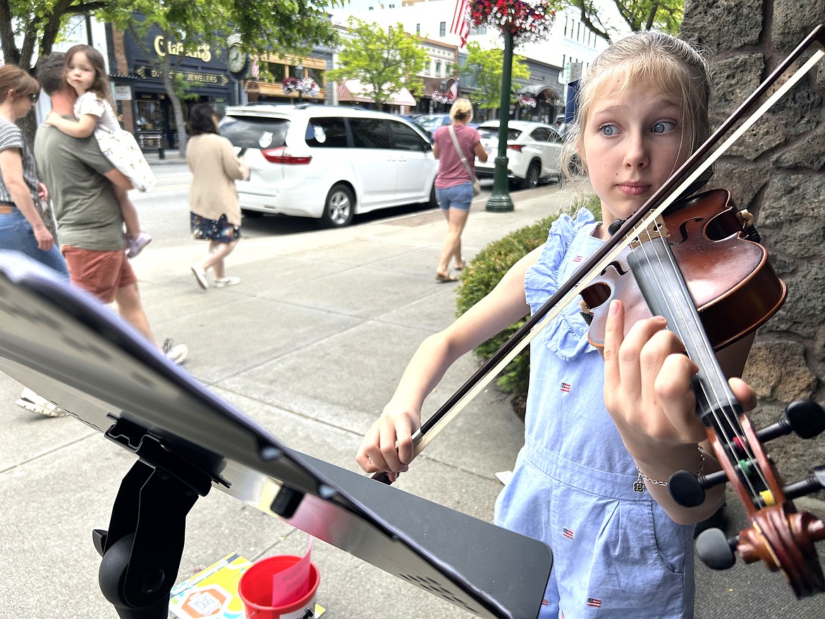 Esther Van Wyk of Coeur d’Alene plays her violin near Third and Sherman on Monday for Street Music Week to benefit Second Harvest.