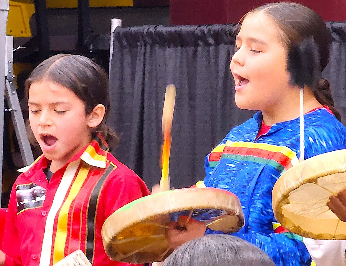 Two singers/drummers from Nkwusm, the Salish language immersion school, sing a Salish prayer at SKC graduation on June 8. (Berl Tiskus/Leader)