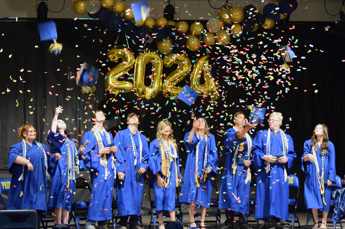 The Wilson Creek High School Class of 2024 throw their caps into the air with bursts of confetti at the end of Saturday’s graduation ceremony in the WCHS gym.