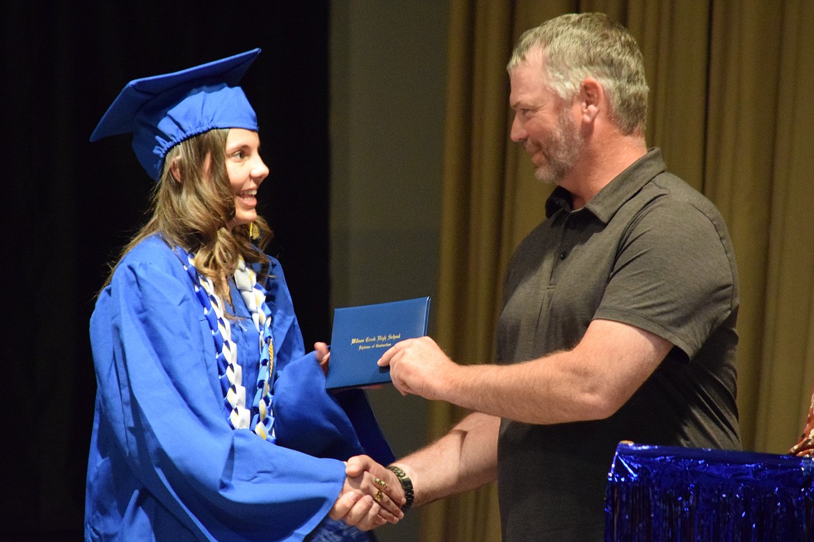 Wilson Creek graduating senior Lucia Rodriguez accepts her diploma during the graduation ceremony Saturday morning. Rodriguez graduated with the highest honors after earning a 3.75 GPA or higher.