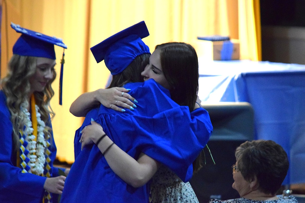A Wilson Creek graduate hugs an audience member during the family and friends tribute portion of Saturday’s ceremony.