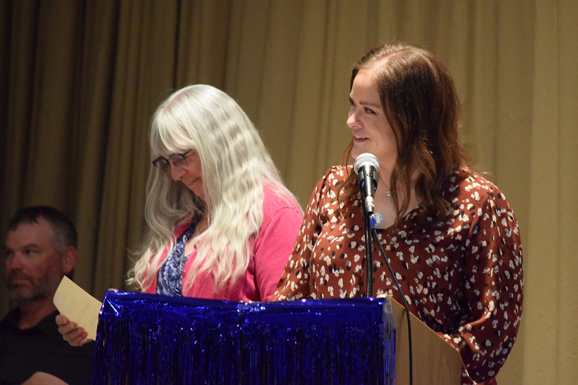 Wilson Creek Dean of Students Anna Thomas, right, and Superintendent Laura Christian, left, hand out scholarships and awards Saturday at Wilson Creek High School’s 2024 graduation ceremony.