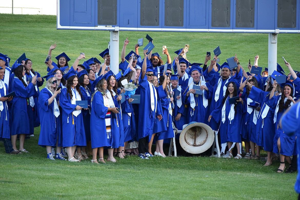 The Warden Cougars Class of 2024 rings the bell to celebrate after finishing receiving their diplomas over the weekend.