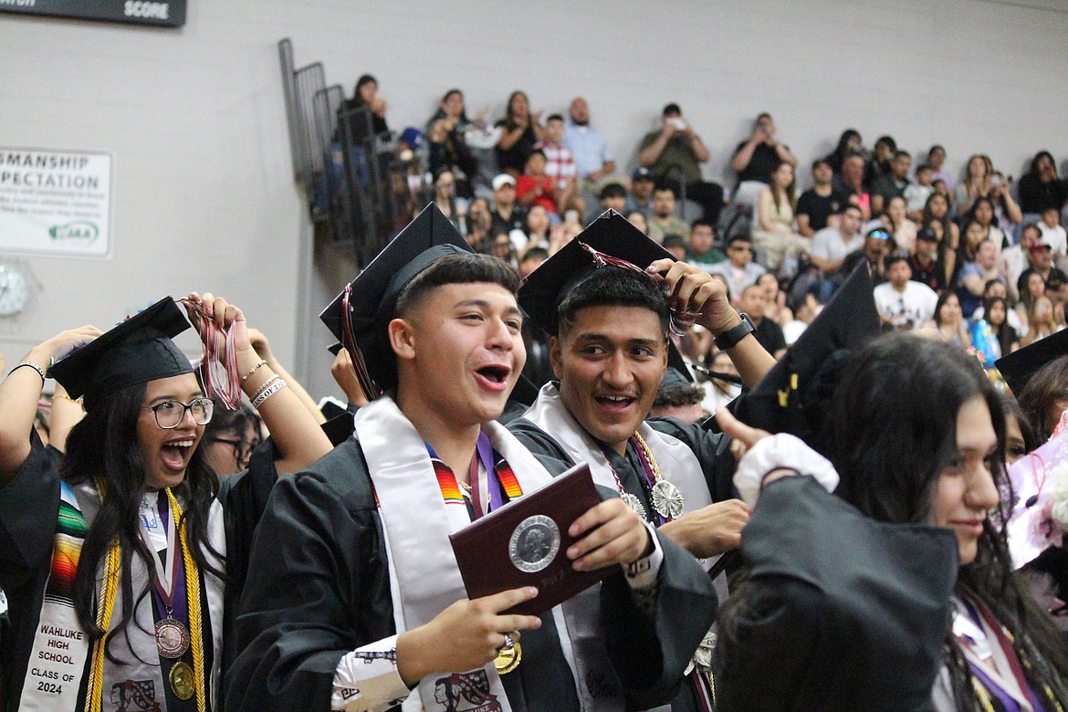 Wahluke seniors move the tassel and celebrate at the end of graduation.