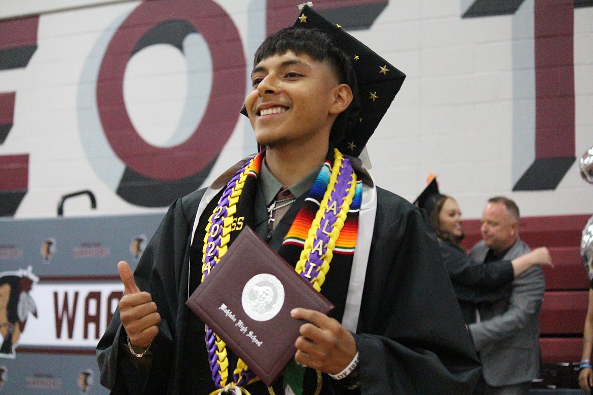 A Wahluke senior shows off his new diploma.