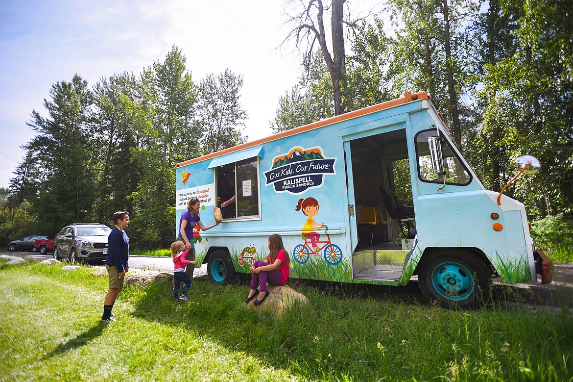 The Kalispell Public Schools Food Service mobile food truck, in partnership with No Kid Hungry, serves free lunches at Lawrence Park in Kalispell on Thursday. The free summer meals program is open to youths ages 18 and under. (Casey Kreider/Daily Inter Lake)