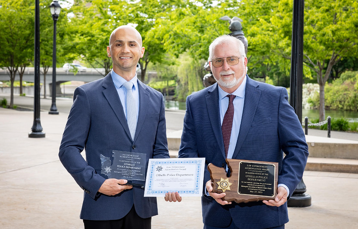 Othello Police Department Chief David Rehaume, right, and Assistant Chief Aaron Garza hold plaques in Spokane after achieving accreditation through the Washington Association of Sheriffs and Police Cheifs.