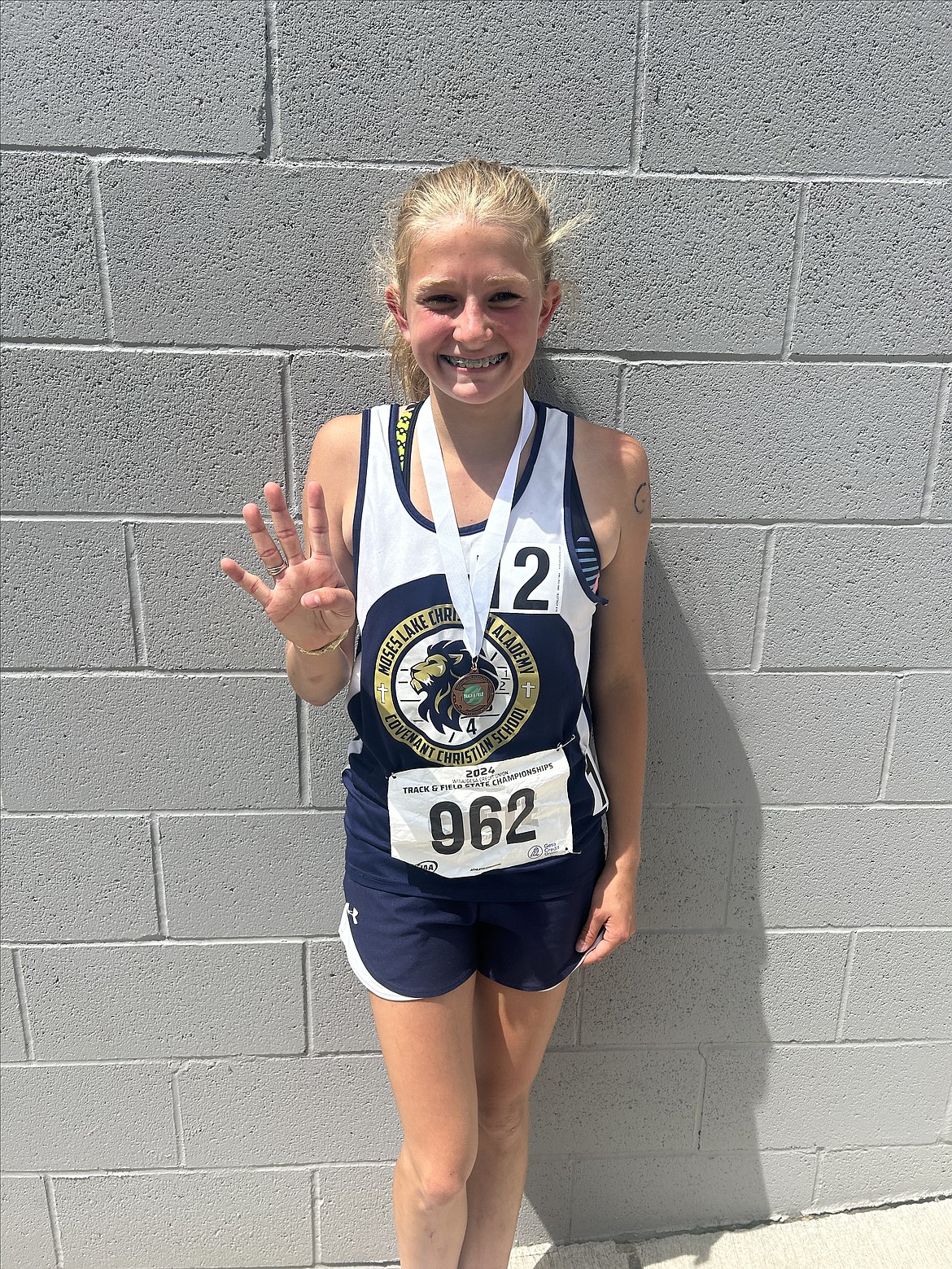 MLCA/CCS eighth-grader Rebecca Wiser smiles with her medal after taking fourth in the 1B girls 3,200-meter run at the 1B State Track and Field Championships in Yakima last month.