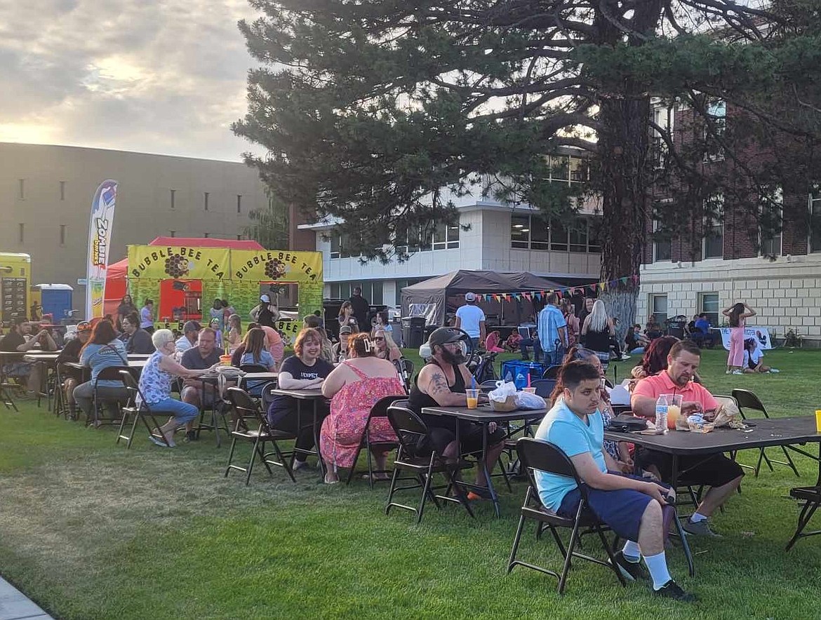 Festival attendees take a break on the southwest side of the Grant County Courthouse lawn where food booths and chairs were set up. A wide variety of food including burgers, jerky, turkey legs and others were available during this year’s event.