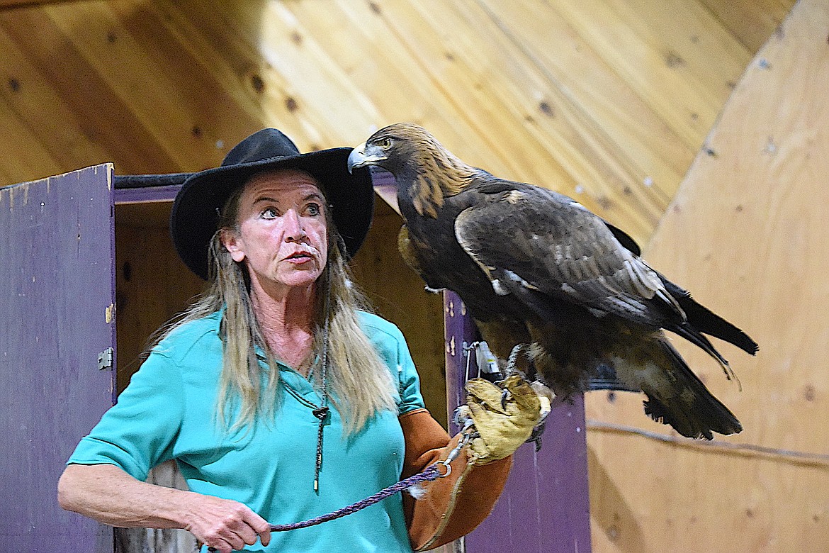 Northwest Birds of Prey's Janie Veltkamp and "Dakota," a golden eagle at Libby Dam's event June 1, 2024, to celebrate International Migratory Bird Day and National Kids to Parks Day. (Scott Shindledecker/The Western News)