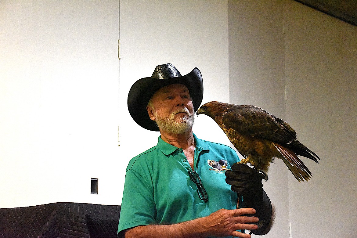 Northwest Birds of Prey's Don Veltkamp and "Rusty," a red-tailed hawk at Libby Dam's event June 1, 2024, to celebrate International Migratory Bird Day and National Kids to Parks Day. (Scott Shindledecker/The Western News)
