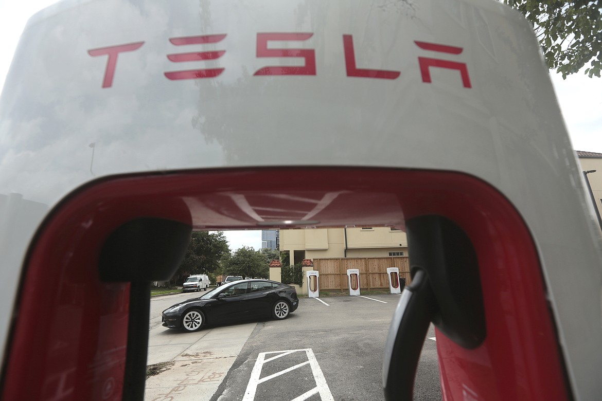 A Tesla supercharging location is seen on Kipling Street, June 3, 2024 in Houston. Charging stations have been hit particularly hard by thieves who likely want to sell the highly conductive copper wiring inside the cables at near-record prices. But authorities and charging company officials say similar thefts are increasing across the U.S. as more charging stations are built. (AP Photo/Lekan Oyekanmi)