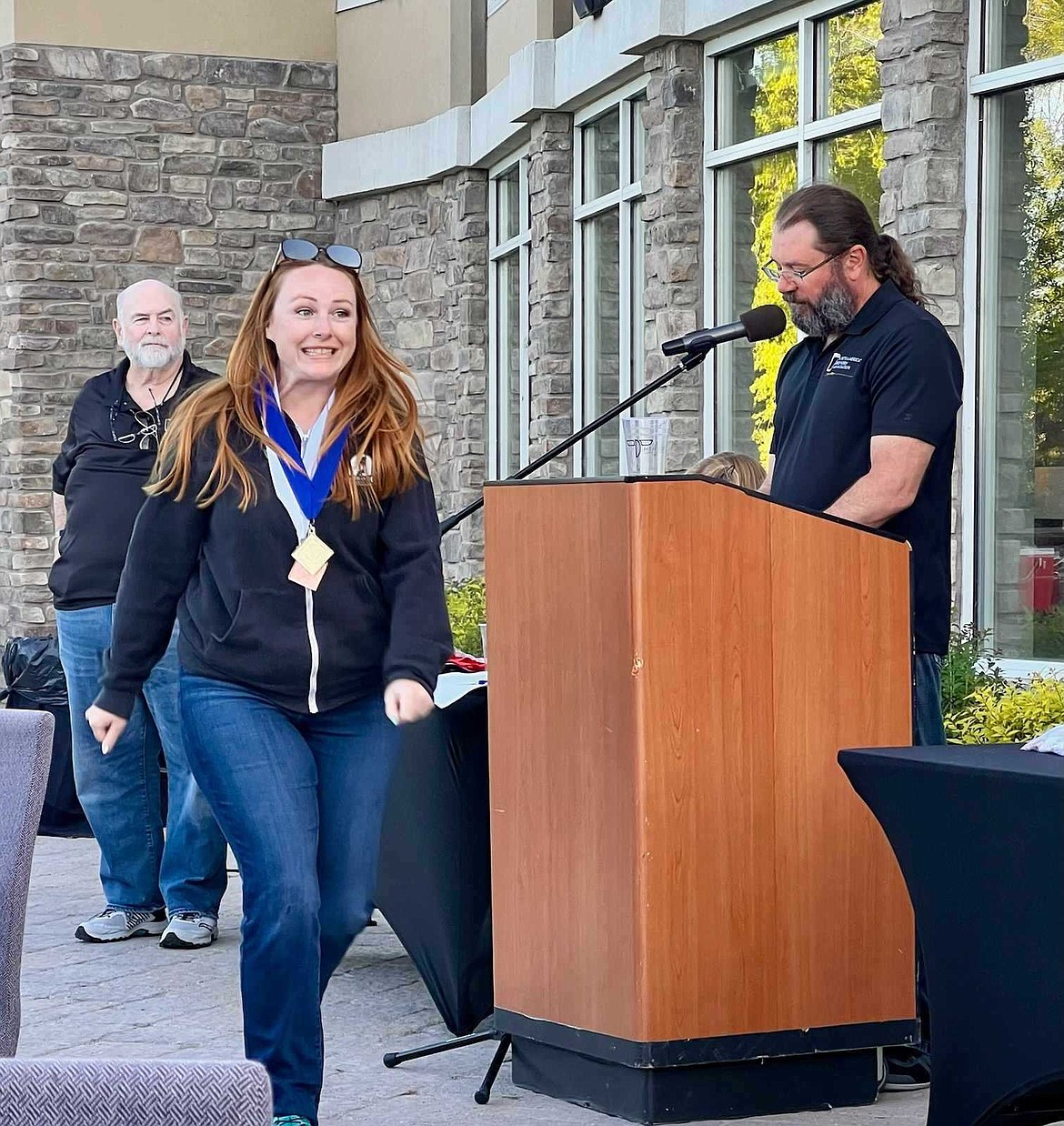 Sarah Mann, Bombastic Brewing's head brewer, accepts the craft brewery's medals during the North American Beer Awards.