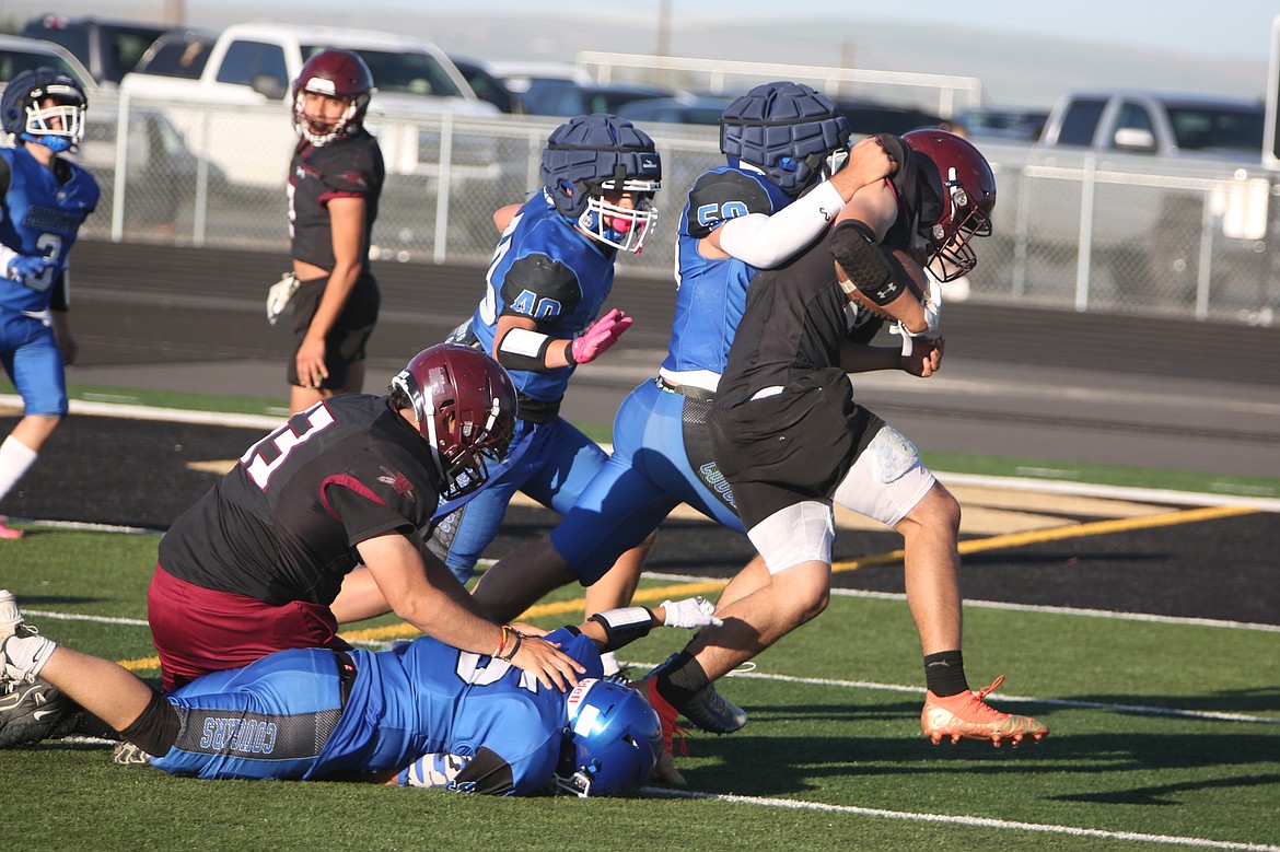 Warden defenders take down a Wahluke running back during Tuesday’s spring jamboree.