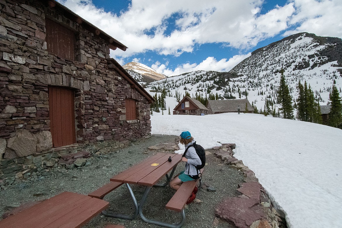 Sam Manaker sits at a picnic table at Granite Park Chalet in Glacier National Park last week. (Ethan Vandenbosch/Hungry Horse News)