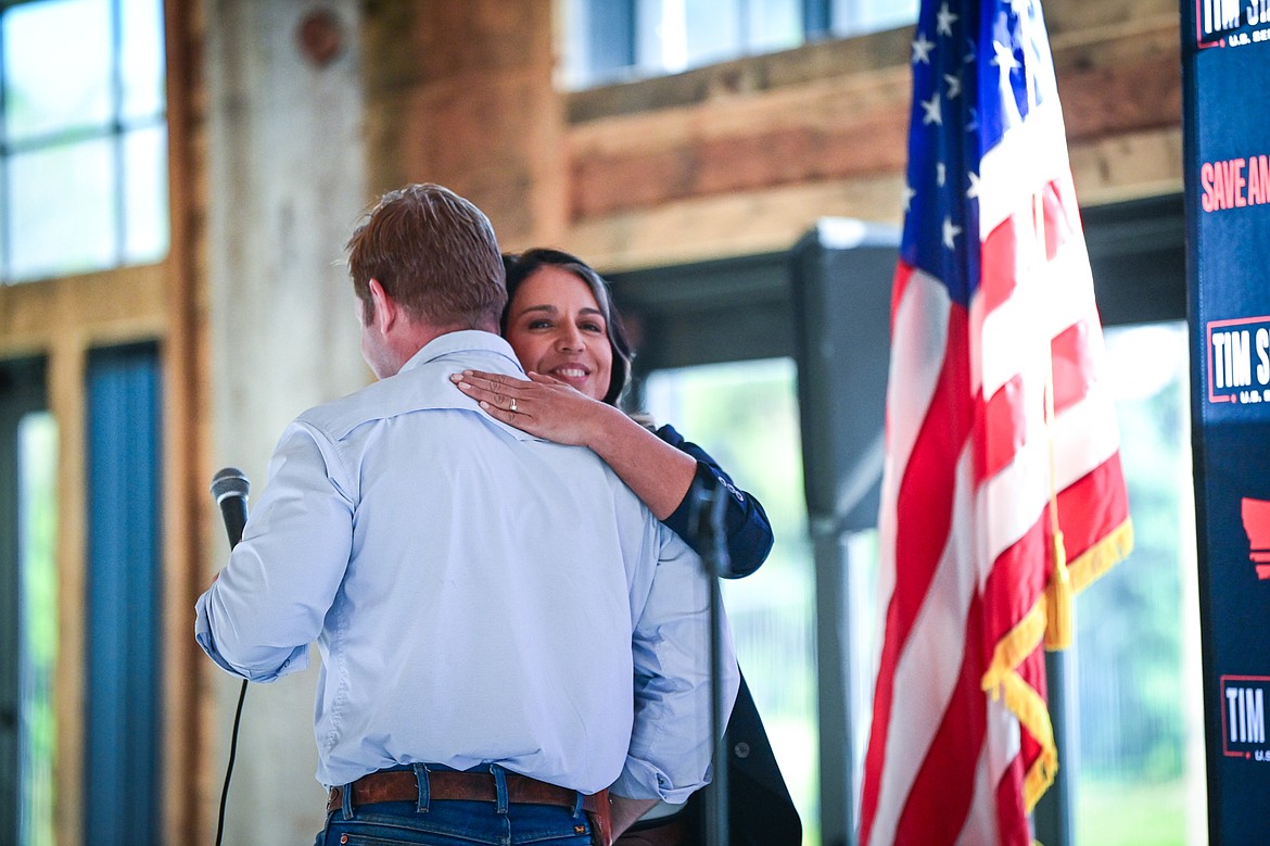 Republican U.S. Senate candidate Tim Sheehy passes the microphone to former congresswoman and 2020 presidential candidate Tulsi Gabbard during a Save America Rally at Snowline Acres in Kalispell on Thursday, June 13. (Casey Kreider/Daily Inter Lake)