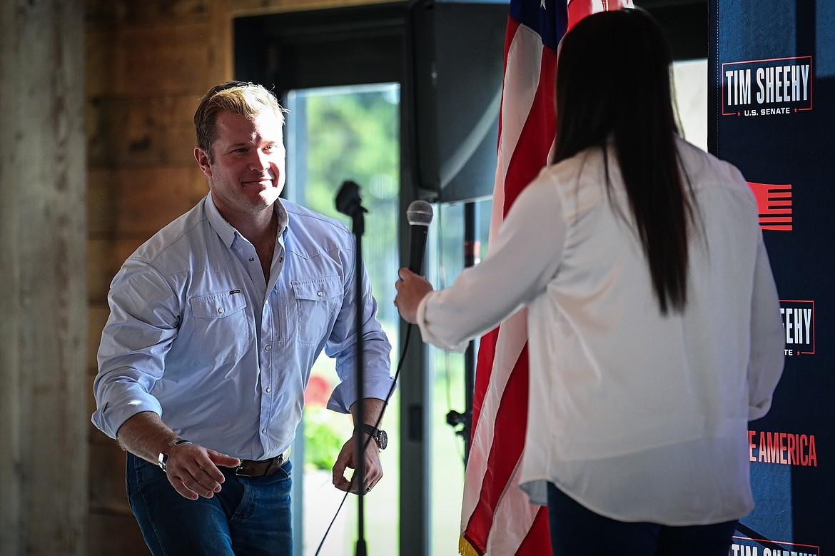 Republican U.S. Senate candidate Tim Sheehy takes the microphone from Rep. Courtenay Sprunger during a Save America Rally at Snowline Acres in Kalispell on Thursday, June 13. (Casey Kreider/Daily Inter Lake)