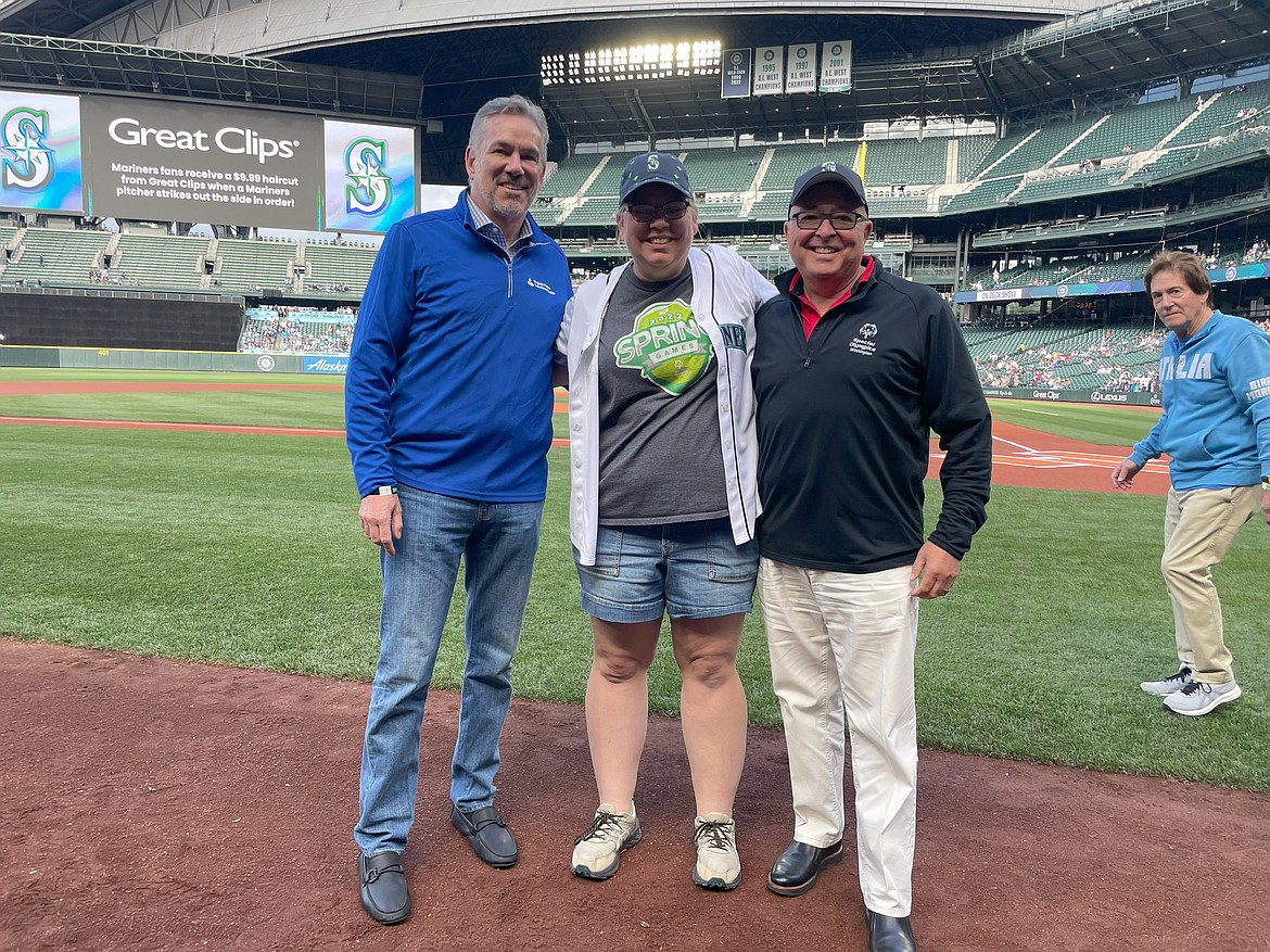 Moses Lake resident and Special Olympian Kassandra Sandgren, center, smiles for a photo before throwing out the ceremonial first pitch at Tuesday’s Seattle Mariners game.